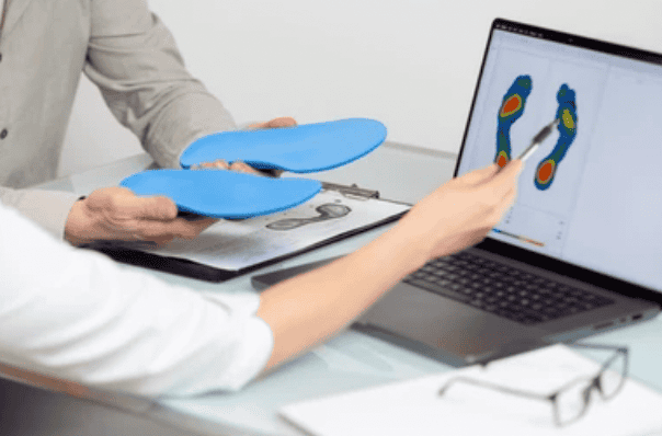 doctor explaining 3d orthotics to patient on computer screen