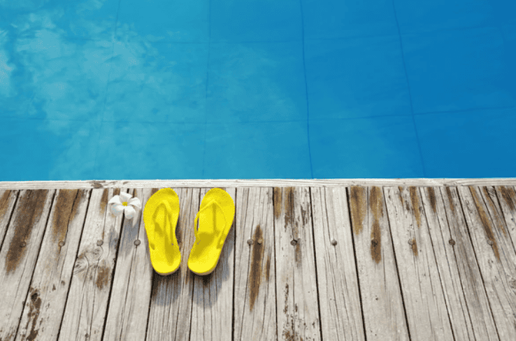 flip flops at edge of pool